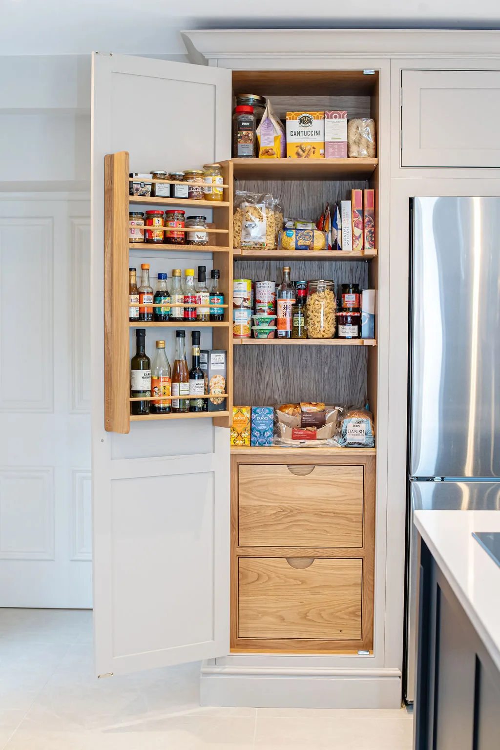 A tall fitted wine cabinet opened to show bottle storage